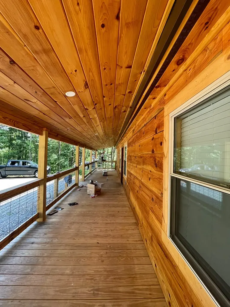 Wood-sided cabin with unfinished deck surface